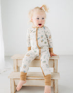 little girl sitting on a step in Meadow Lane Kids Heirloom Homestead TENCEL toddler sleeper